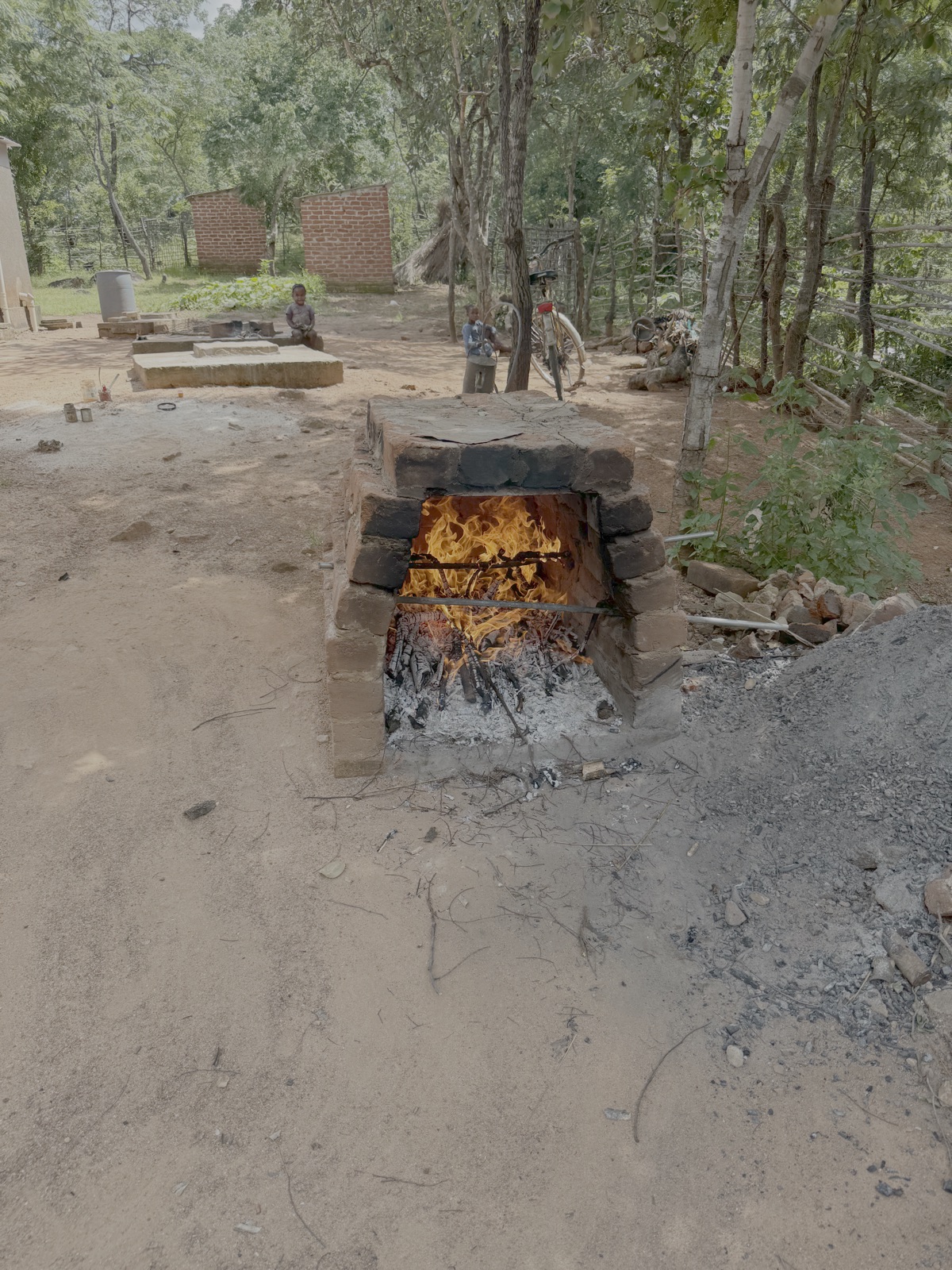 Uitleg over de werking van de oven. Eerst wordt deze verhit met vuur van sprokkelhout
